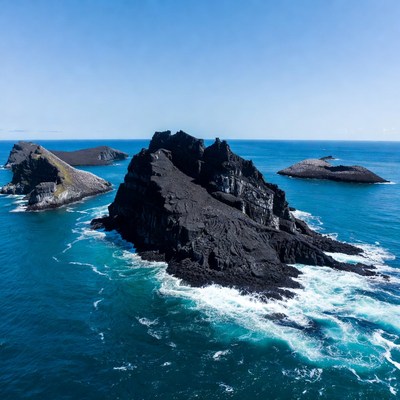 Black rocks in blue sea
