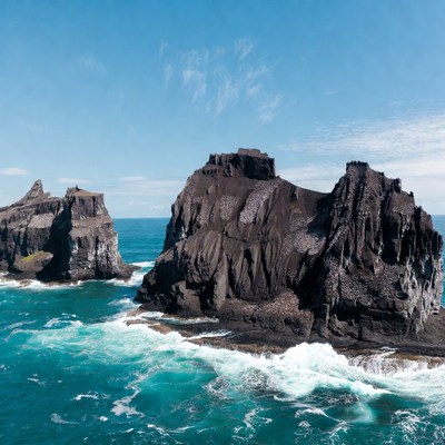 Rugged coastline with dark cliffs and waves