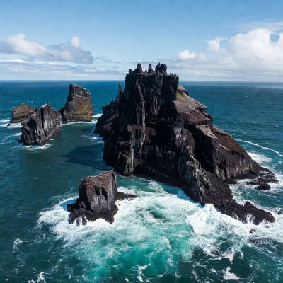Rocky island in the ocean under blue sky