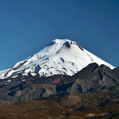 Snowy peak of mountain in sunlight