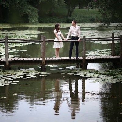 Couple holding hands on bridge