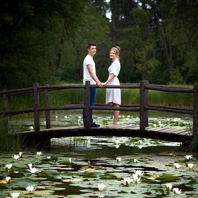 Couple on bridge at pond