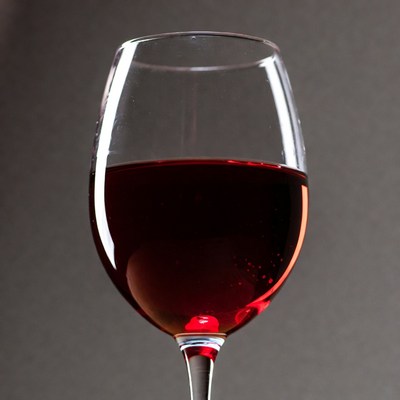 Red wine in glass on dark background