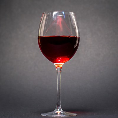 Red wine in glass on dark background