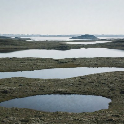 Landscape of lakes and hills in the distance