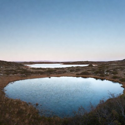 Water bodies in a vast landscape in twilight