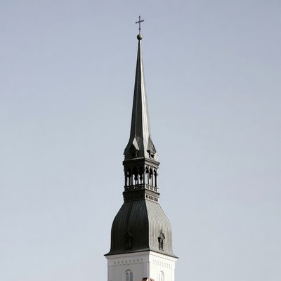 Tall church spire against blue sky