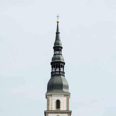 Tall church spire stands against sky