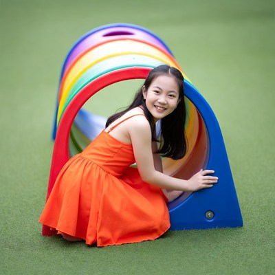 Girl playing at playground tunnel