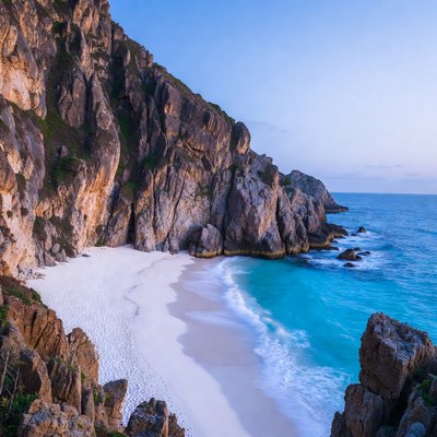 Coastal rocks and sandy beach at dusk