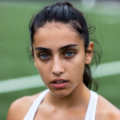 Young athlete on sports field in training