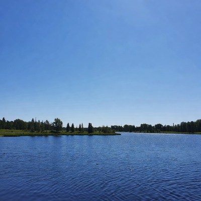 Clear blue lake under bright sky