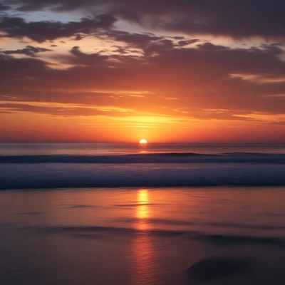 Sunset over calm ocean waves