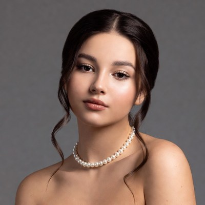 Model poses with pearls indoors