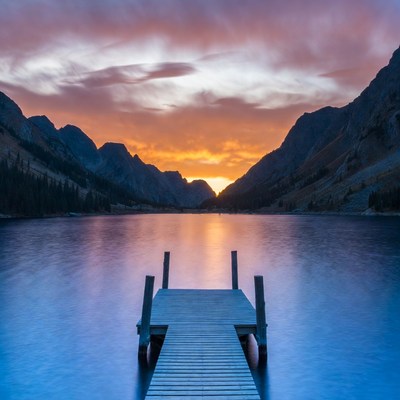 Sunset at mountain lake dock