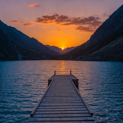 Sunset over mountain lake dock