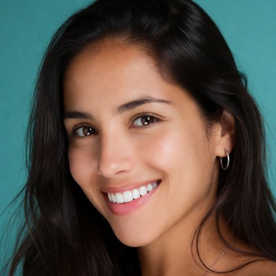 Woman smiles against blue background