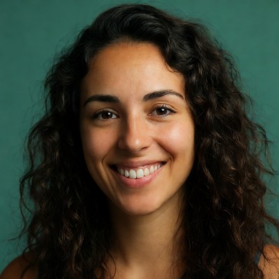 Woman smiling against green background