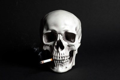 Skull with cigarette smoke background