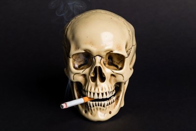 Skull with cigarette resting in mouth