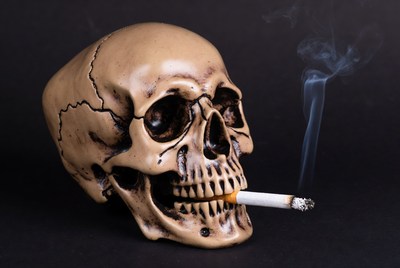 Skull with cigarette smoke