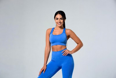 Woman posing in blue workout clothing