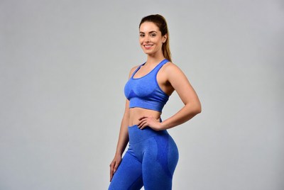 Woman posing in activewear studio setting