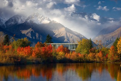 Mountains and autumn colors reflect in water