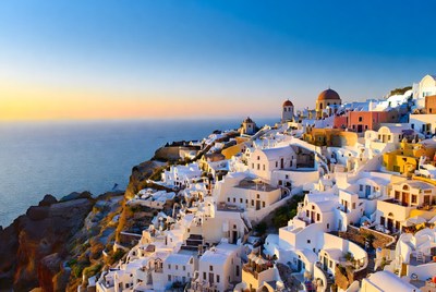 Sunset over santorini rooftops by the sea