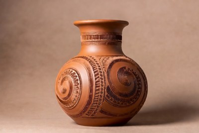 Handcrafted clay vase with intricate design