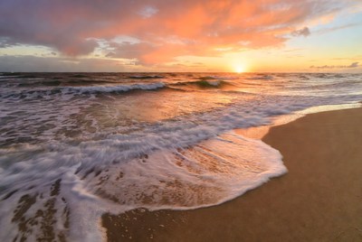 Sunset at the beach with waves