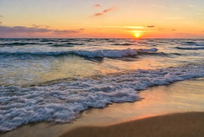 Sunset over the ocean waves