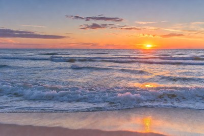 Sunset over the ocean waves