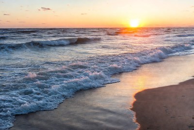 Sunset over the ocean waves