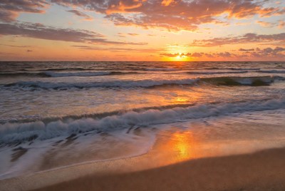Sunset over the ocean waves