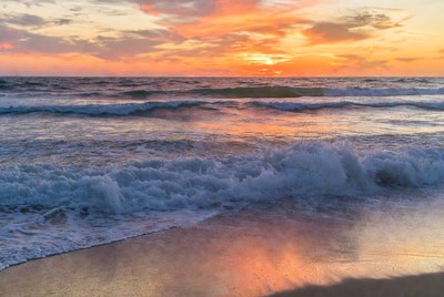Sunset over the ocean waves