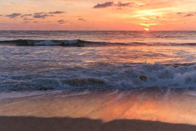 Sunset over the ocean waves