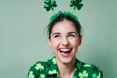 Smiling person with shamrock accessories