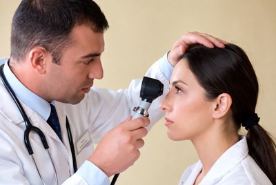 Doctor checks patient's eyes during examination