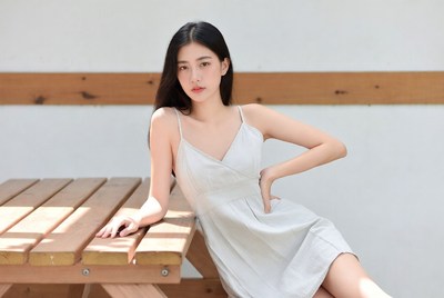 Model posing near wooden table
