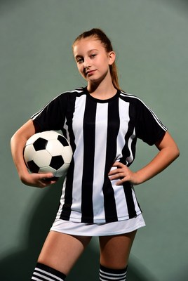 Young girl holding a soccer ball