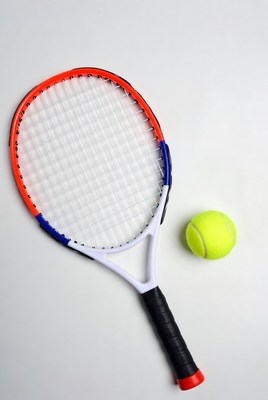 Tennis racket and ball on a surface