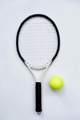 Tennis racket and ball on white background