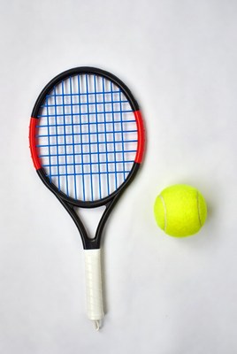Tennis racket and ball on white background