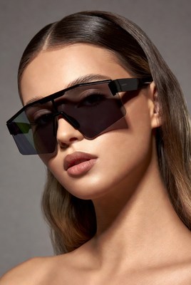 Model poses with sunglasses in studio