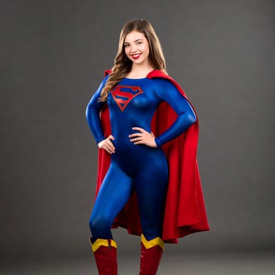 Superhero in blue costume poses