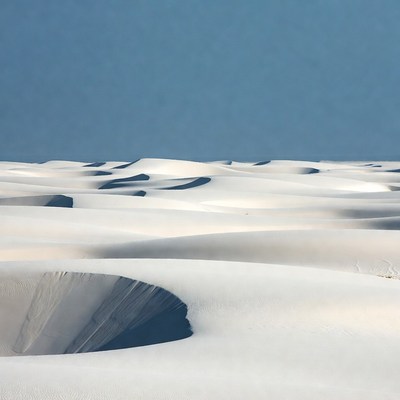 White sand dunes stretch across landscape