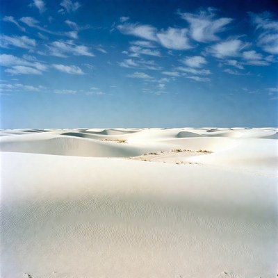 White sand dunes under blue sky