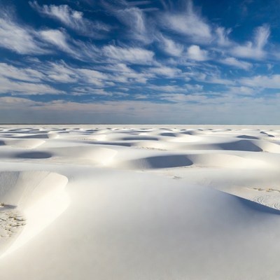 White sand dunes under blue sky