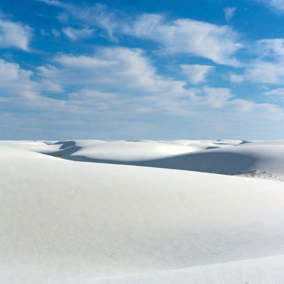 White sand dunes under blue sky